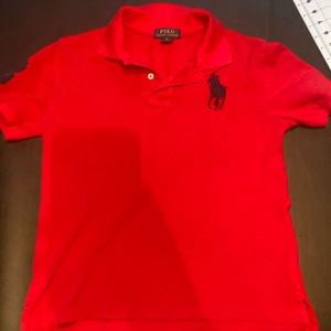 Red short sleeve polo shirt. Size 10–12 medium. With buttons and polo sign.